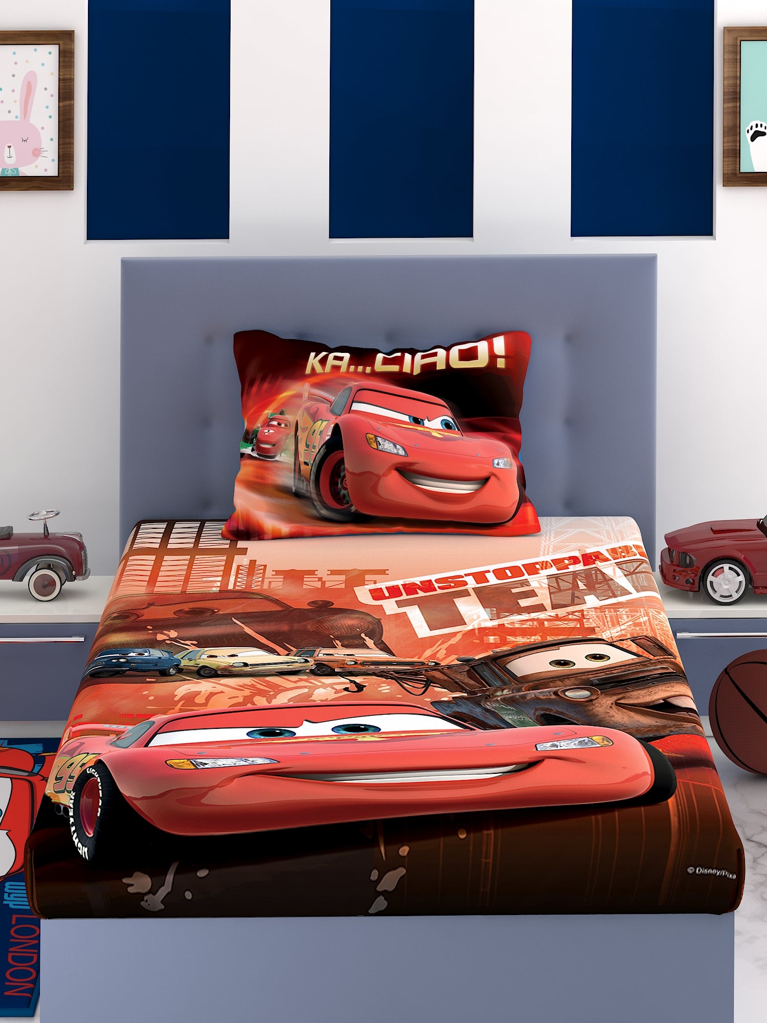 a bed with a red blanket and two pillows