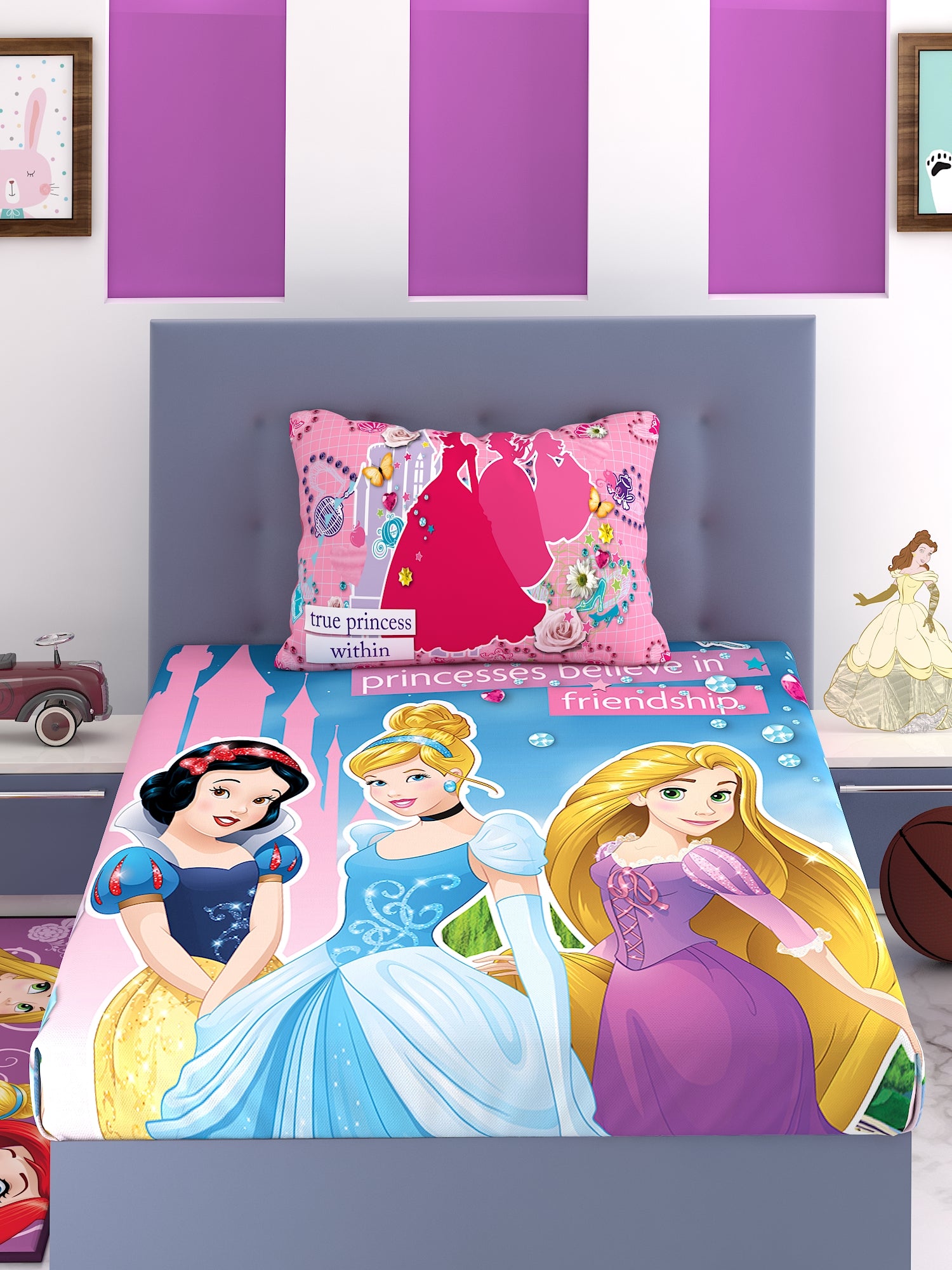 a bed with a colorful blanket and two pillows